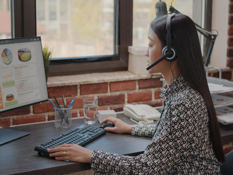 close-up-asian-woman-with-headphones-talking-phone-call-people-customer-service-consultant-using-headset-microphone-working-call-center-computer-support-chat_482257-35265